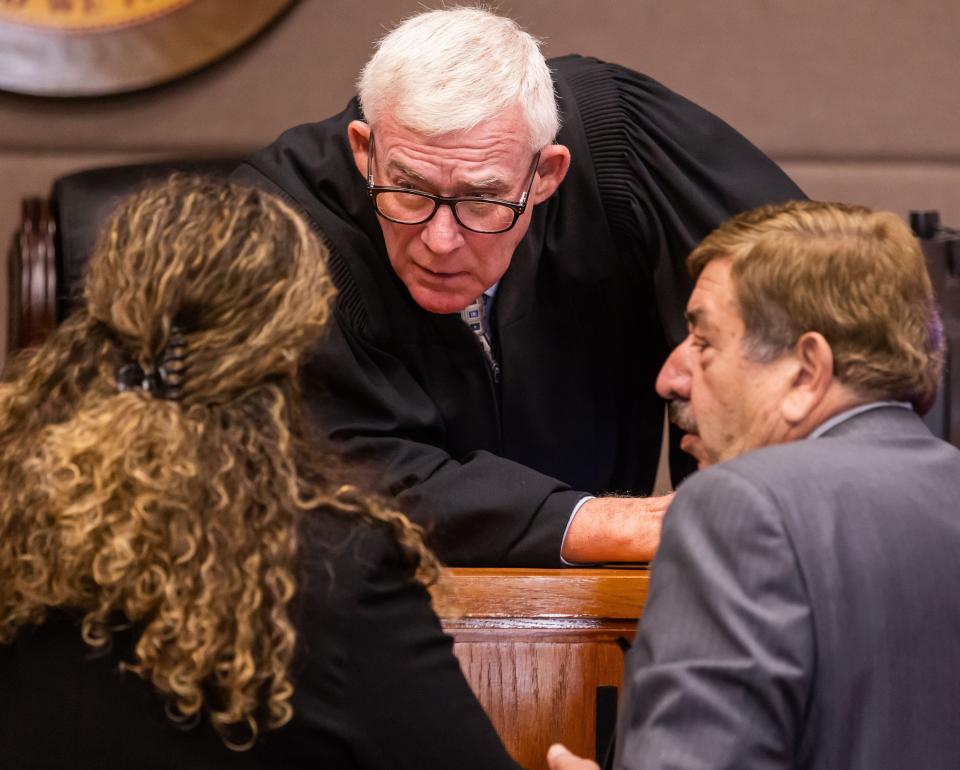Judge Willard Pope, center, has a conference with Assistant State Attorney Sasha Kidney, left, and defense attorney Jack Maro while overseeing the second-degree murder trial of Jennifer S. Hill, on Tuesday morning at the Marion County Judicial Center.