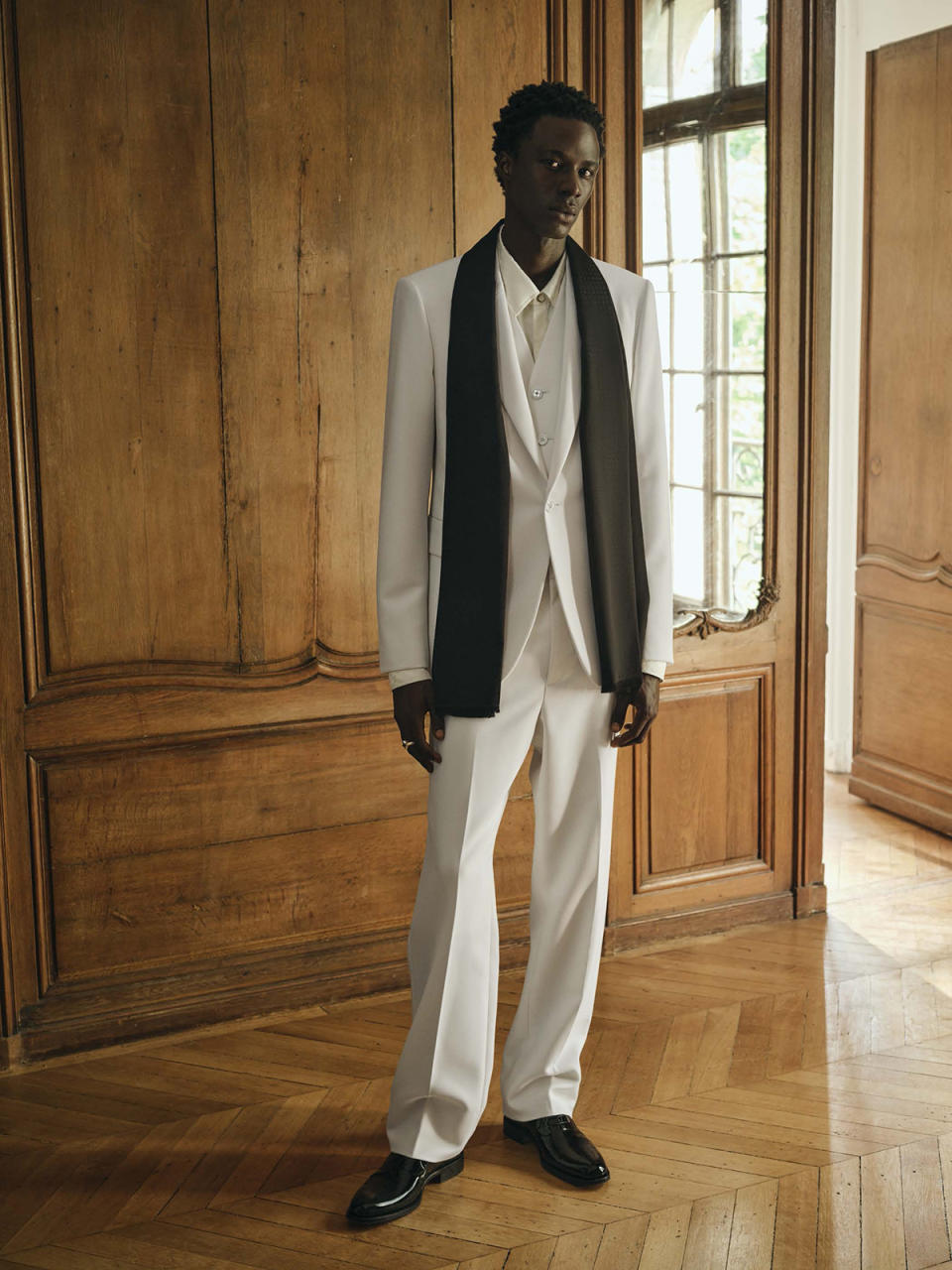 A three-piece wool-blend evening look in white from Louis Vuitton Men's New Formal collection.