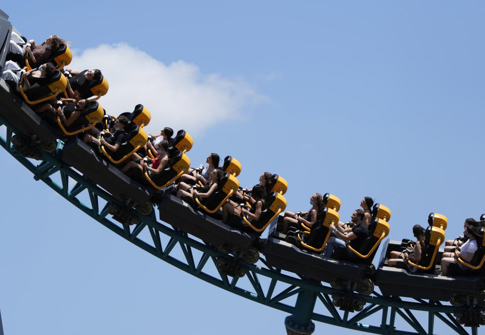 People enjoy a ride at Cinecitta World amusement park in the outskirts of Rome in the day of its reopening, Thursday, June 17, 2021. Amusement parks have been closed since Oct. 25 2020, when Italy's second national lockdown started. (AP Photo/Alessandra Tarantino)