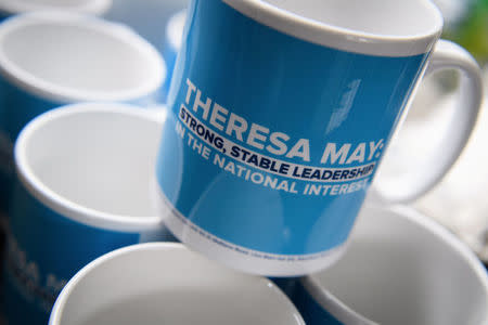 Conservative party election campaign mugs are seen on the battle bus as it departs following an election campaign event held by Britain's Prime Minister Theresa May in Wolverhampton, May 30, 2017. REUTERS/Leon Neal/Pool