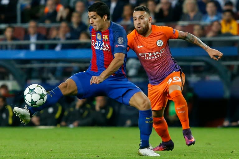 Barcelona's forward Luis Suarez (L) vies with Manchester City's defender Nicolas Otamendi during the UEFA Champions League football match FC Barcelona vs Manchester City at the Camp Nou stadium in Barcelona on October 19, 2016