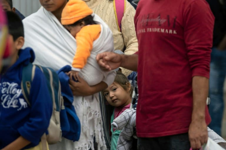 Migrants line up at El Chaparral port of entry in Tijuana, Mexico