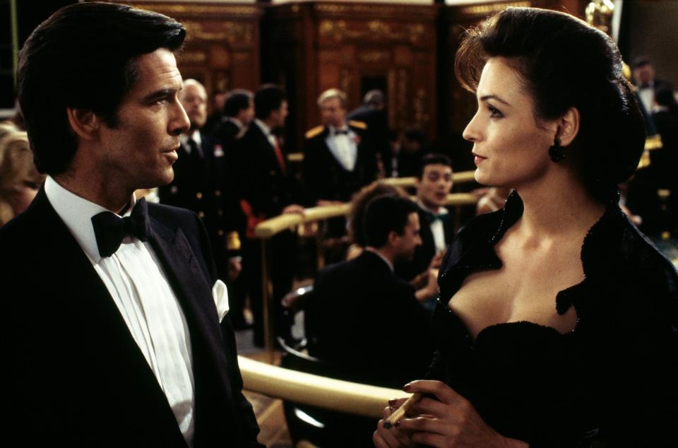 Irish actor Pierce Brosnan stars as James Bond alongside Dutch-born actress Famke Janssen as the villainous Xenia Onatopp in the film 'GoldenEye', 1995. Here they are filming a scene in the Casino de Monte Carlo, Monte Carlo, Monaco.