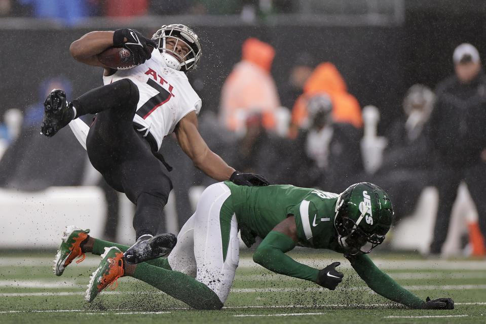 New York Jets cornerback Sauce Gardner (1) upends Atlanta Falcons running back Bijan Robinson (7) during the third quarter of an NFL football game, Sunday, Dec. 3, 2023, in East Rutherford, N.J. (AP Photo/Adam Hunger)