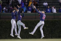 The Minnesota Twins outfielders from left, Jake Cave, Nick Gordon, and Max Kepler celebrate the team's 5-4 win over the Chicago Cubs after a baseball game Wednesday, Sept. 22, 2021, in Chicago. (AP Photo/Charles Rex Arbogast)
