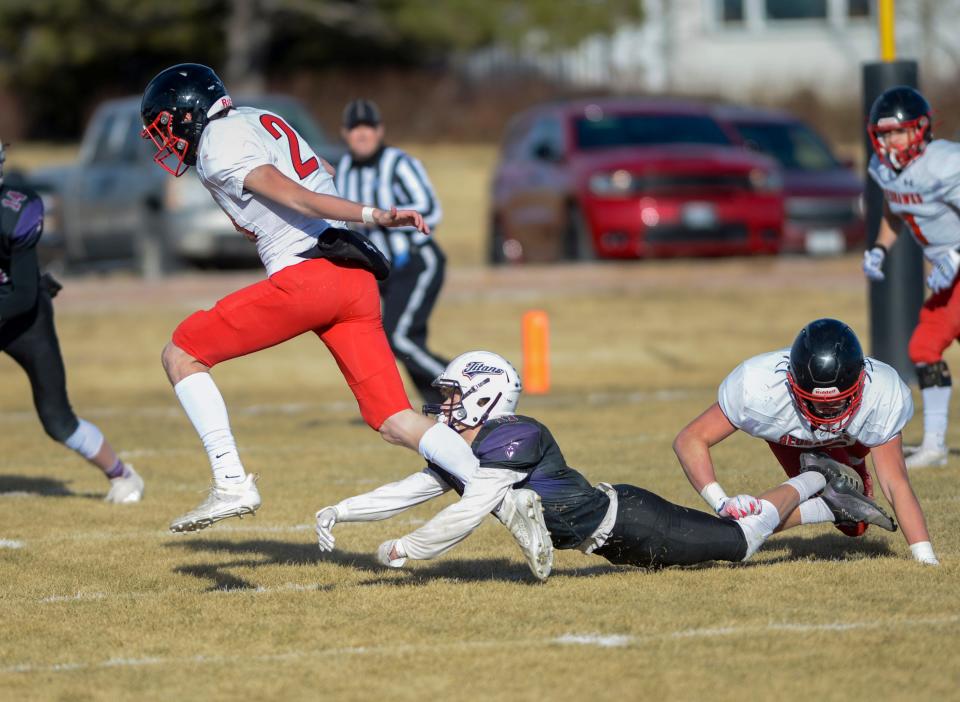 Froid/Medicine Lake quarterback Mason Dethman carries the football as Power/Dutton/Brady's Spencer Lehnerz attempts to make the tackle in Saturday's 6-player football championship game in Dutton.