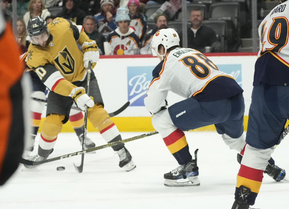 Vegas Golden Knights center Nicolas Roy, left, shoots the puck for a goal past Colorado Avalanche defenseman Andreas Englund (88) in the second period of an NHL hockey game Monday, Jan. 2, 2023, in Denver. (AP Photo/David Zalubowski)