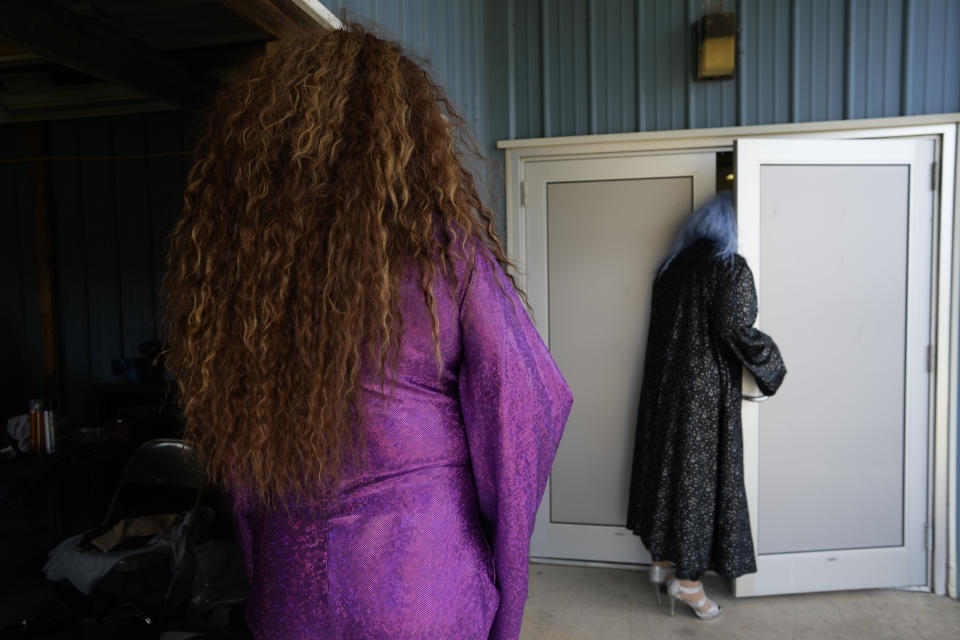 Drag queens Tequila Daniels, aka Tony Nahodil, left, and her drag daughter, Trixy Valentine, aka Jacob Kelley, pause before entering a "Drag Bingo" fundraiser at the Nescopeck Township Volunteer Fire Company Social Hall, in Nescopeck, Pa., Saturday, March 18, 2023, to raise money for a new roof for the Berwick Theater and Center for Community Arts, in Berwick, Pa. (AP Photo/Carolyn Kaster)