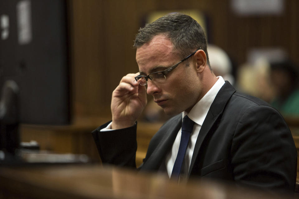 Oscar Pistorius, sits in the dock at a court in Pretoria, South Africa, Monday, March 17, 2014. Pistorius is on trial for the murder of his girlfriend Reeva Steenkamp on Valentines Day, 2013. (AP Photo/Daniel Born, Pool)