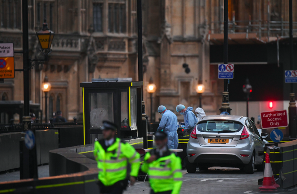 <em>Police and forensic teams surround the car used in the attack (PA)</em>