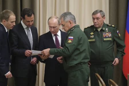 Russian President Vladimir Putin (C), Syrian President Bashar al-Assad (2nd L), Russian Defence Minister Sergei Shoigu (2nd R) and Chief of the General Staff of Russian Armed Forces Valery Gerasimov (R) attend a meeting in the Black Sea resort of Sochi, Russia November 20, 2017. Sputnik/Mikhail Klimentyev/Kremlin via REUTERS