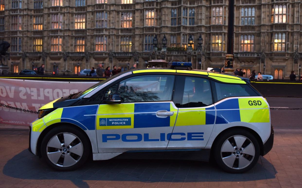 A BMW i3 electric Metropolitan Police car outside the Houses of Parliament, 2019