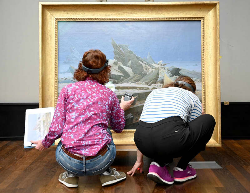 Kerstin Krainer (R), conservator Alte Nationalgalerie and Eva Keochakian, conservator Hamburger Kunsthalle examine the painting "The Sea of Ice" by Caspar David Friedrich (1774-1840) for transport damage. To mark the 250th anniversary of the artist's birth, the Alte Nationalgalerie, in cooperation with the Kupferstichkabinett of the Staatliche Museen zu Berlin, is presenting a major exhibition on the work of the most important painter of German Romanticism. Alina Schmidt/dpa