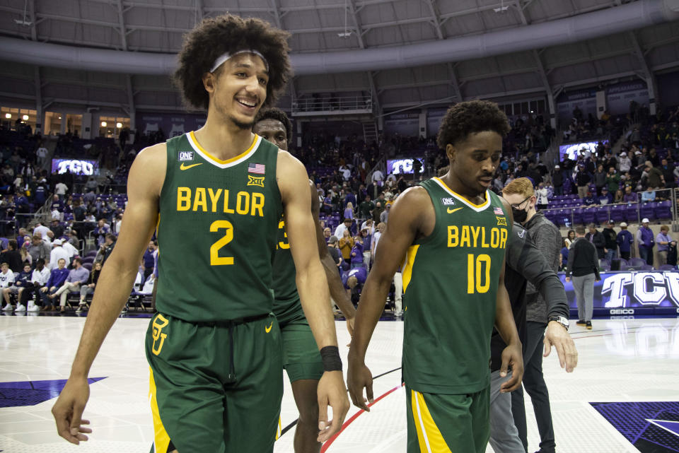 Baylor guard Kendall Brown (2) smiles as he, forward Jonathan Tchamwa Tchatchoua, center back, and guard Adam Flagler (10) walk off the floor after an NCAA college basketball game against TCU in Fort Worth, Texas, Saturday, Jan. 8, 2022. (AP Photo/Emil Lippe)