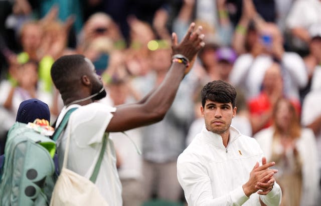 Carlos Alcaraz applauds Frances Tiafoe off the court