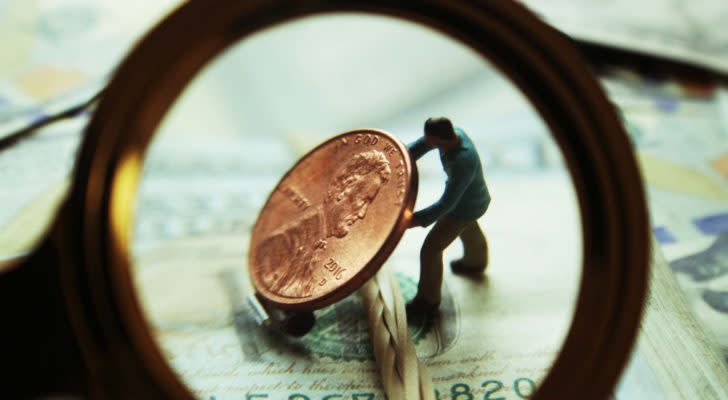 A man lifting a penny under a microscope representing NXTD Stock.