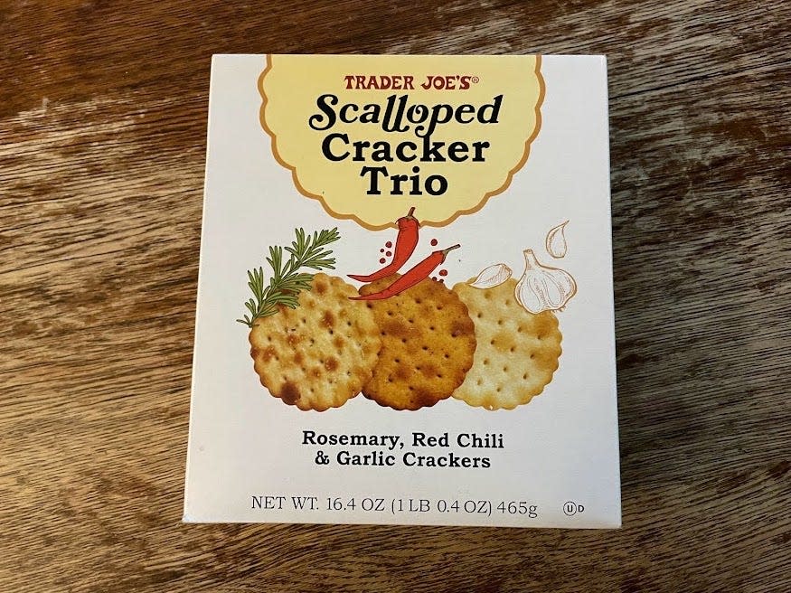 White box of Trader Joe's scalloped cracker trio on a wooden table