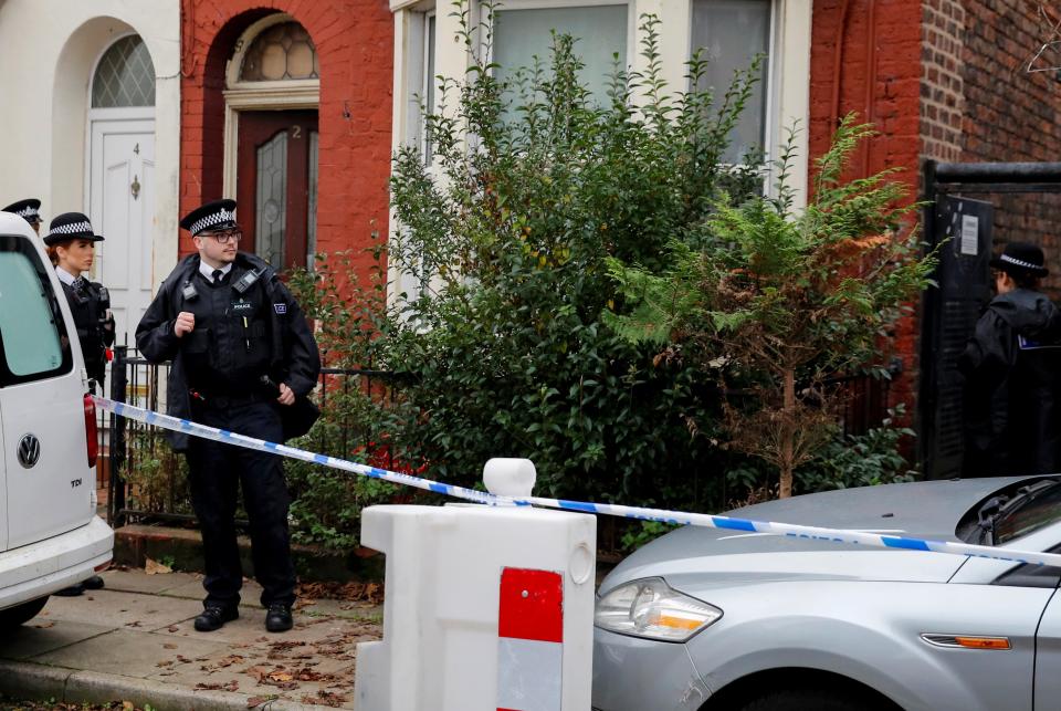 Police officers keep guard outside a house in Kensington, where counter-terrorism officers arrested men on Sunday (REUTERS)