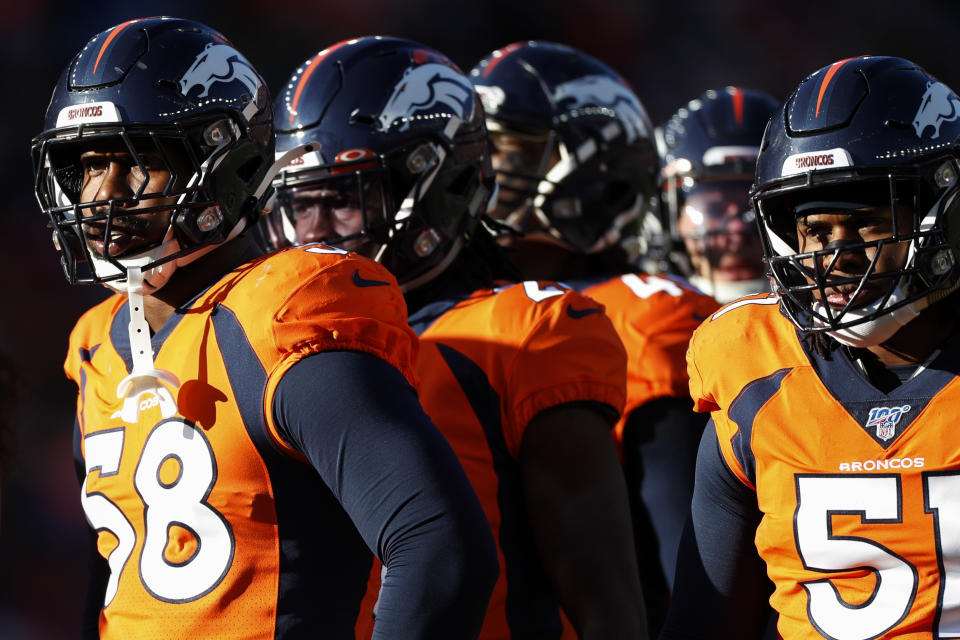 Denver Broncos outside linebacker Von Miller, left, and members of the defense look on during the first half of an NFL football game against the Oakland Raiders, Sunday, Dec. 29, 2019, in Denver. (AP Photo/David Zalubowski)