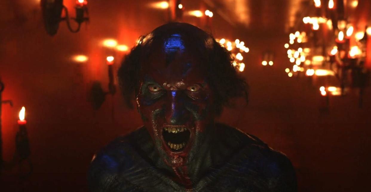 a red faced demon screams in a scene from insidious the red door