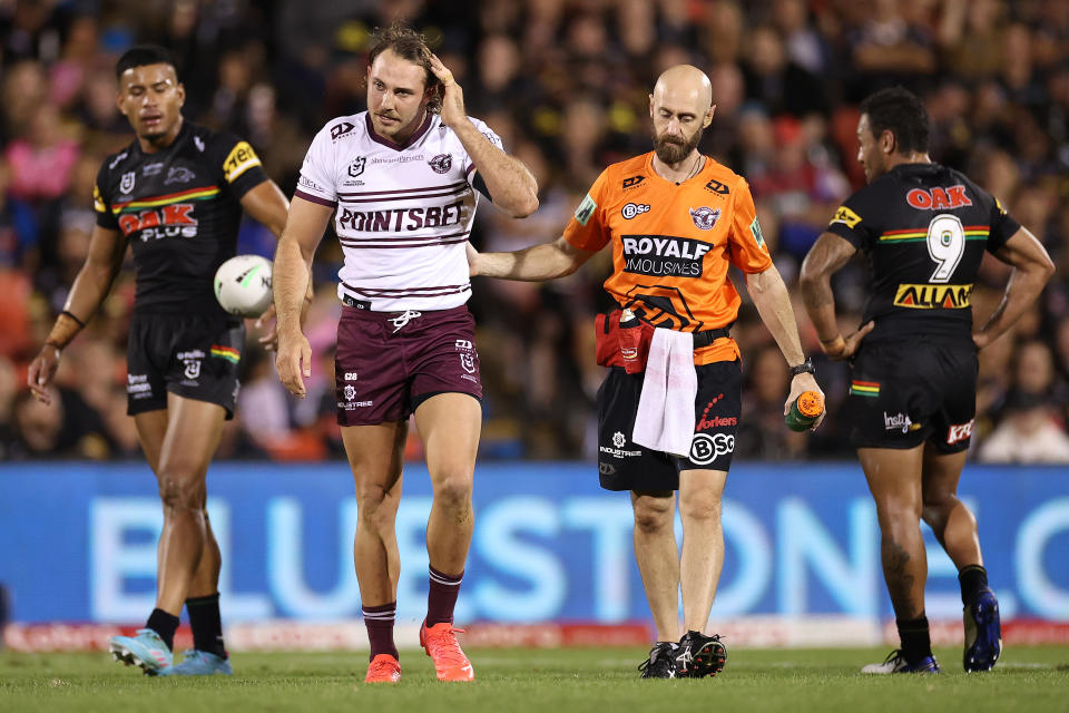 Karl Lawton, pictured here being taken off the field for a HIA during Manly's clash with Penrith.