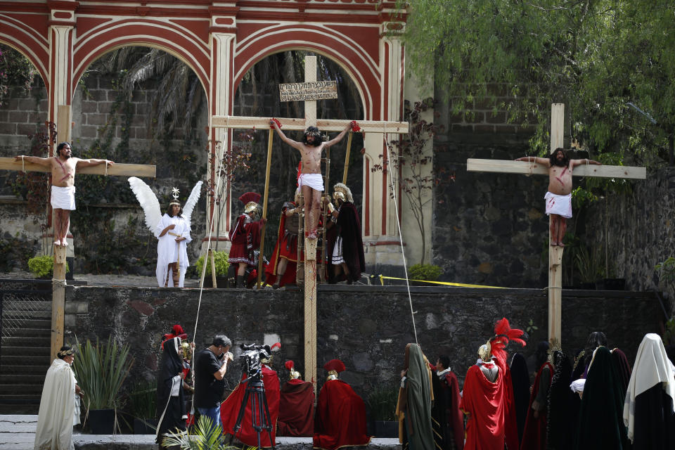 Brando Neri Luna, center, and other cast members reenact the crucifixion of Jesus Christ in the Passion Play of Iztapalapa, outside the Cathedral, on the outskirts of Mexico City, Friday, April 2, 2021, amid the new coronavirus pandemic. To help prevent the spread of the COVID-19, Latin America's most famous re-enactment of the crucifixion of Christ was closed to the public and transmitted live so people could watch at home, for a second consecutive year. (AP Photo/Marco Ugarte)