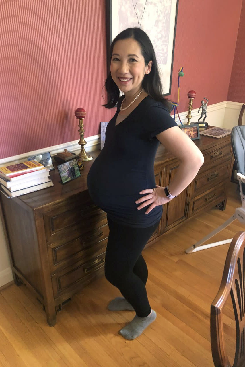 CORRECTS TO GEORGE WASHINGTON UNIVERSITY, NOT GEORGETOWN - In this March 30, 2020 photo, Dr. Leana Wen poses for a photo in her Baltimore home. Wen, a George Washington University public health specialist, who is pregnant and due to give birth soon, says she wants answers as a physician and as a patient to her concerns over the coronavirus. Her greatest fear is developing a COVID-19 infection or symptoms that would force her to be separated from her newborn for days or weeks. “I would only be able to see my baby through a glass window. ... That’s the one that gives me nightmares.” (Courtesy Dr. Leana Wen via AP)