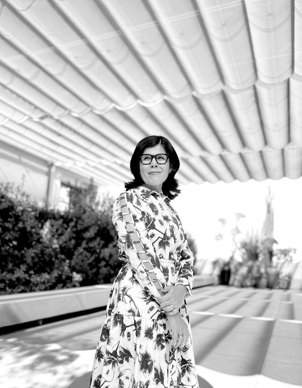 A lady with a floral dress on in an outdoor space