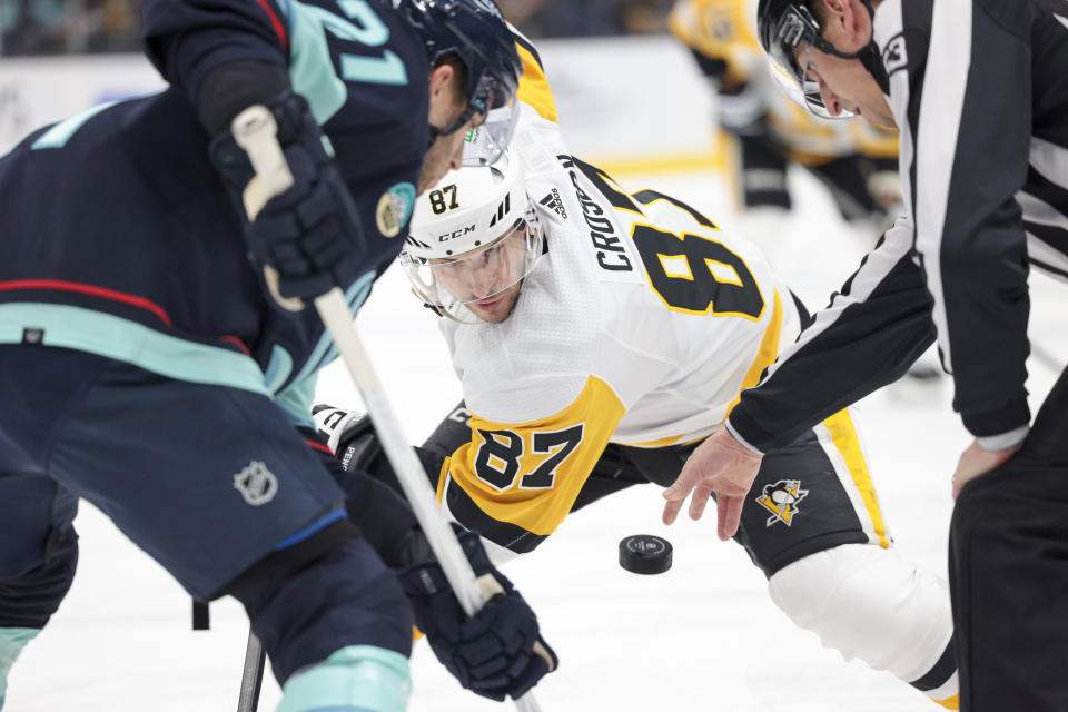 Pittsburgh Penguins center Sidney Crosby (87) faces off against Seattle Kraken center Alex Wennberg (21) during the second period of an NHL hockey game Thursday, Feb. 29, 2024, in Seattle. (AP Photo/Jason Redmond)