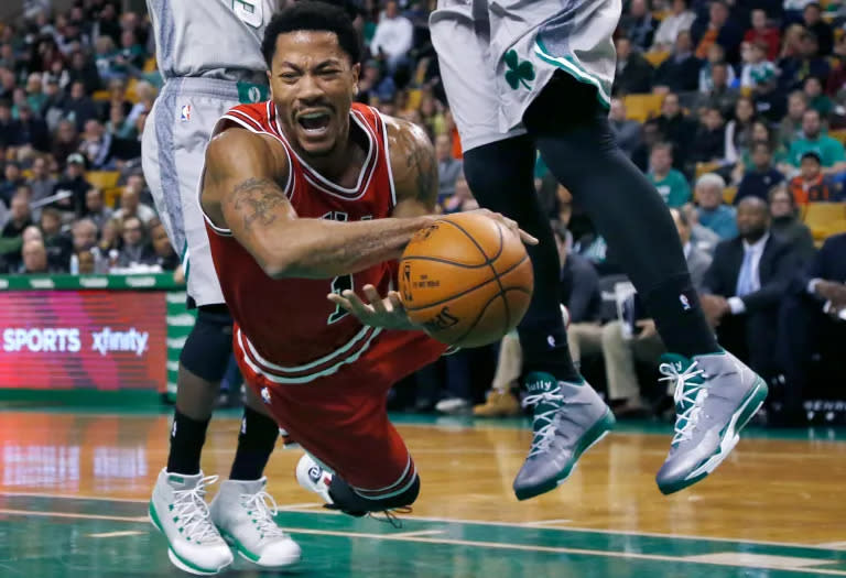 Chicago Bulls guard Derrick Rose falls after being tripped while driving against the Boston Celtics in the first half of an NBA basketball game in Boston, Nov. 28, 2014. (Photo by Elise Amendola, AP, File)