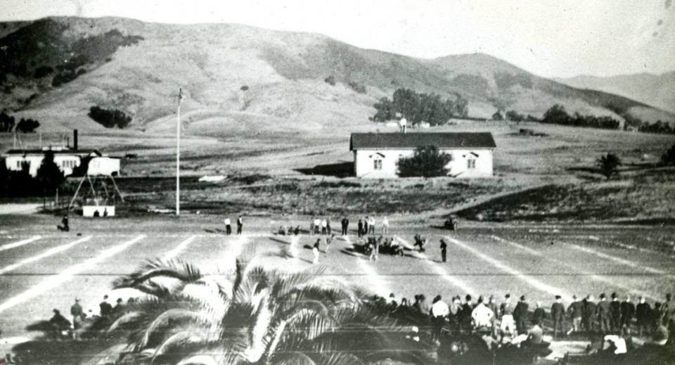 CAL POLY FOOTBALL…A 1917 Thanksgiving day football game at Cal Poly was preserved for posterity by this picture which comes from the collection of Mrs. Zaidee Andrews of Atascadero. The rolling grasslands pictured in the background are now completely filled in with Cal Poly classrooms, dormitories, shops, parking lots and other requirements of the lear-by-doing college. In the days of this picture, Poly Mustangs competed against neighboring high schools.