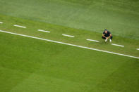 Spain's head coach Luis Enrique crouches by the touchline during the World Cup group E soccer match between Japan and Spain, at the Khalifa International Stadium in Doha, Qatar, Thursday, Dec. 1, 2022. (AP Photo/Petr David Josek)