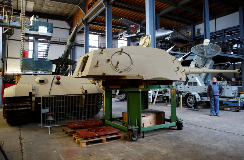 Kubicki stands in front of the turret of a German World War II Tiger II "King Tiger" tank during restoration works at Swiss Military Museum Full in Full