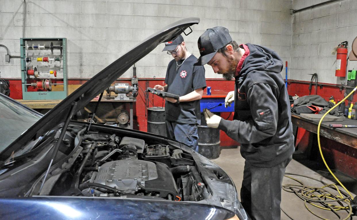 Greg Stanley, left, and Jon Lemon work on a vehicle at WrenchWorks on North Main Street in Orrville. The business opened in Orrville in January. It also has a location in Wadsworth.