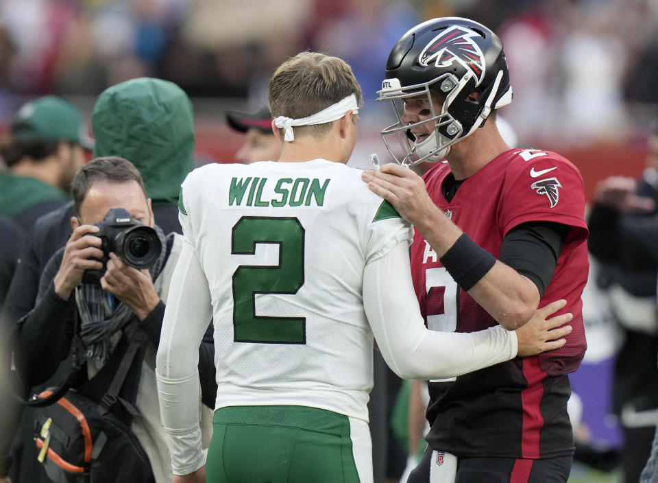 Atlanta Falcons quarterback Matt Ryan (2) greets New York Jets quarterback Zach Wilson (2) after an NFL football game between the New York Jets and the Atlanta Falcons at the Tottenham Hotspur stadium in London, England, Sunday, Oct. 10, 2021. Atlanta Falcons won the match 27-20. (AP Photo/Alastair Grant)