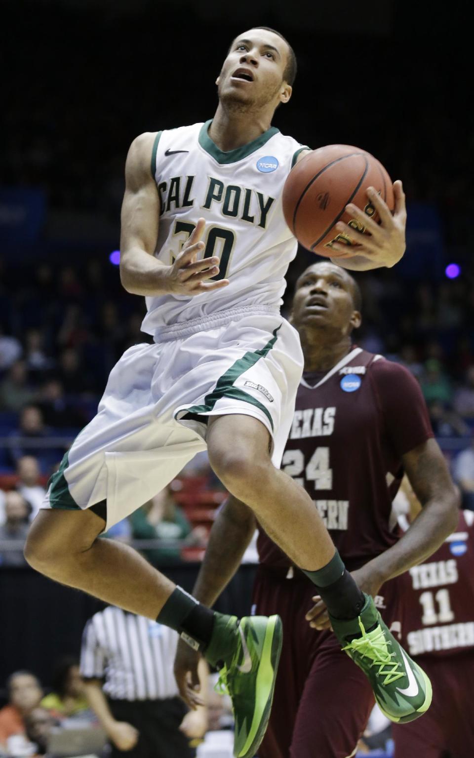 Cal Poly guard Michael Bolden drives past Texas Southern center Aaric Murray (24) in the first half of a first-round game of the NCAA college basketball tournament on Wednesday, March 19, 2014, in Dayton, Ohio. (AP Photo/Al Behrman)