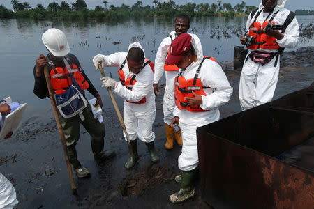 Members of the joint task force, part of the Bodo oil spill clean-up operation, inspect the site of an illegal refinery near the village of Bodo in the Niger Delta, Nigeria August 2, 2018. REUTERS/Ron Bousso