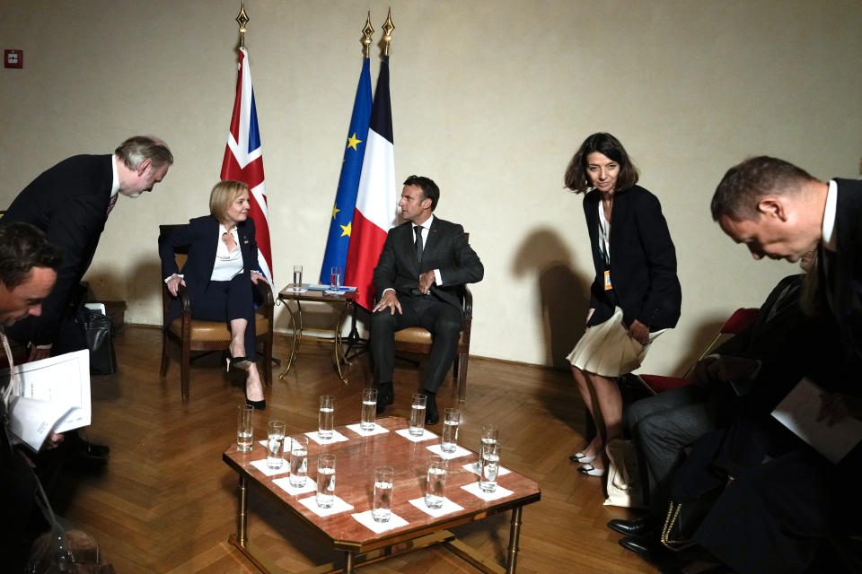 Members of the delegations take their seats as British Prime Minister Liz Truss, center left, and France's President Emmanuel Macron, center right, meet on the sidelines of the European Political Community meeting at Prague Castle in Prague, Czech Republic, Thursday, Oct 6, 2022. Leaders from around 44 countries are gathering Thursday to launch a "European Political Community" aimed at boosting security and economic prosperity across the continent, with Russia the one major European power not invited. (AP Photo/Alastair Grant, Pool)