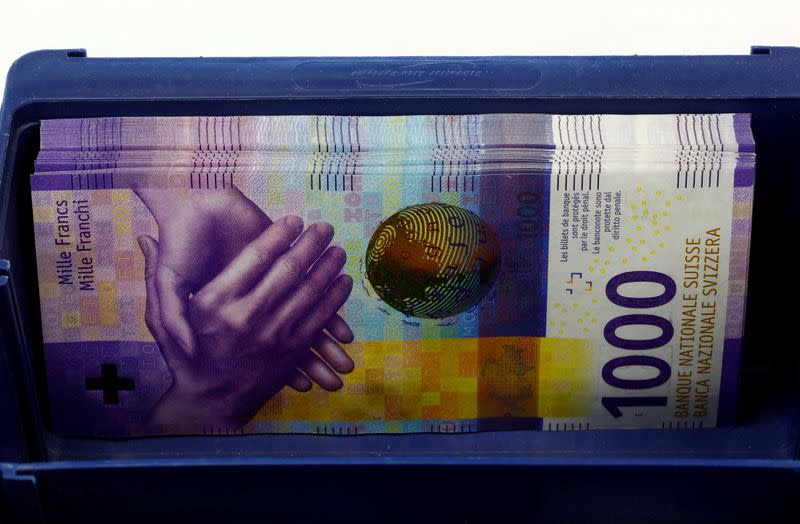 FILE PHOTO: FILE PHOTO: 1,000-Swiss-franc banknotes lie in a box at a Swiss bank in Zurich