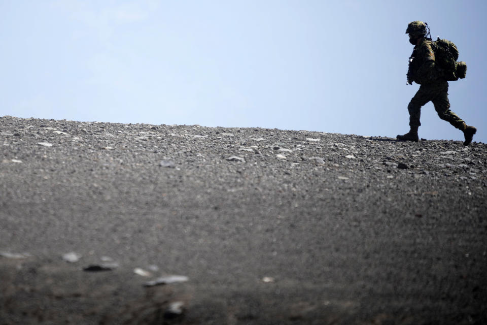 One of members of Japan Ground Self-Defense Force (JGSDF) takes part in a joint military helicopter borne operation drill between JGSDF and U.S. Marines at Higashi Fuji range in Gotemba, southwest of Tokyo, Tuesday, March 15, 2022. (AP Photo/Eugene Hoshiko)