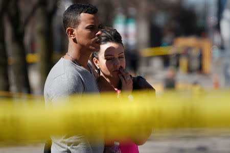 Witnesses are pictured at the scene of an incident where a van struck multiple people on Yonge Street in Toronto, Ontario, Canada April 23, 2018. REUTERS/Carlo Allegri