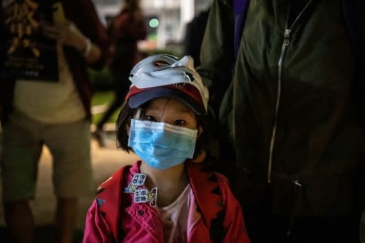 A little girl looks on as she takes part in a rally in Tamar Park on November 9