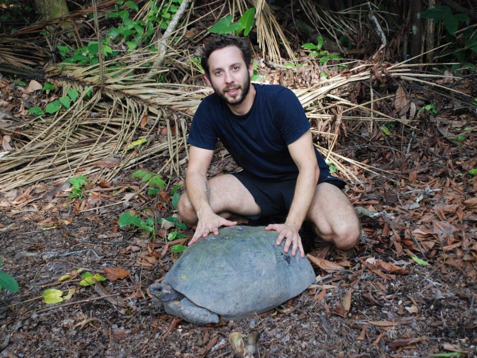 Gabriel Jorgewich-Cohen poses with a tortoise