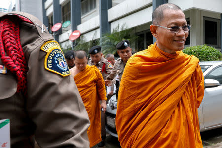 Phra Phrom Dilok, 72, a member of the Sangha Supreme Council is escorted by police officers at the Thai Police Crime Suppression Division headquarters in Bangkok, Thailand, May 24, 2018. REUTERS/Stringer