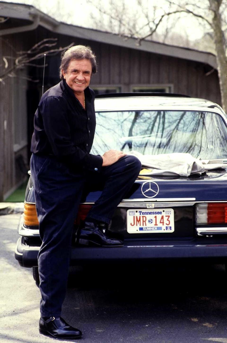 Johnny Cash shows off a car in the driveway, 1988. (Photo: Getty Images)
