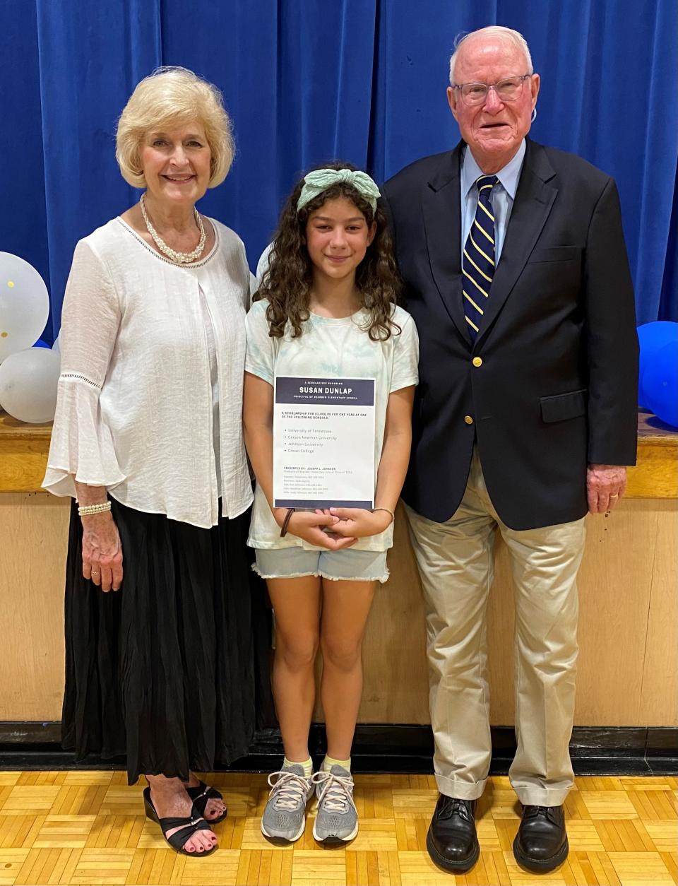 Fifth-grader Coraline Lee was named the recipient of the Susan Dunlap Scholarship at Bearden Elementary during an awards program on May 23, 2022. At left is principal Susan Dunlap and at right is Joe Johnson, donor of the future college scholarship worth $1,000.