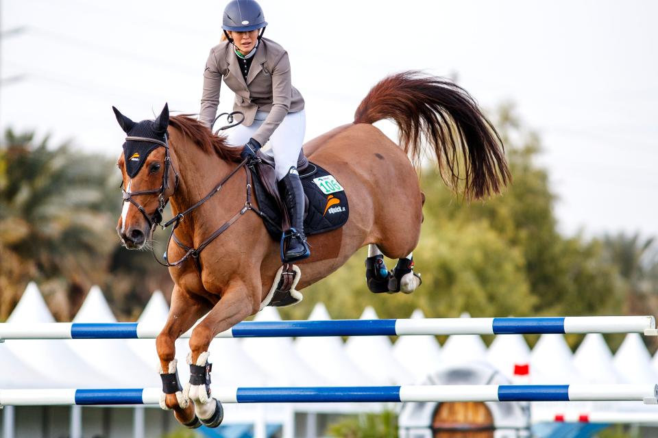 Professional show jumper Ashlee Bond warms-up during the Major League Show Jumping Tour at Desert International Horse Park in Thermal, Calif., on Thursday, December 1, 2022. 