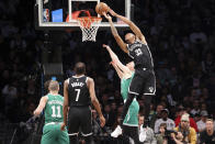 Brooklyn Nets forward Nic Claxton (33) scores a basket against Boston Celtics forward Sam Hauser as Boston Celtics guard Payton Pritchard (11) and Brooklyn Nets forward Kevin Durant (7) watch during the first half of an NBA basketball game, Sunday, Dec. 4, 2022, in New York. (AP Photo/Jessie Alcheh)