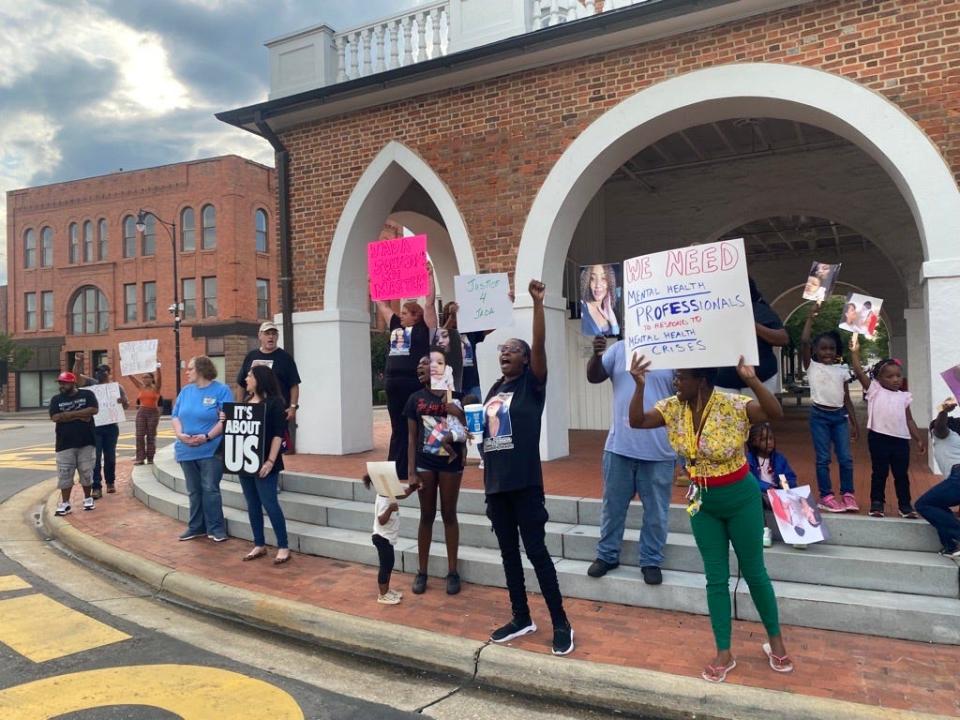 Protestors at the Market House chant and hold signs to call for police reform in the wake of Jada Johnson's death. Johnson, 22, was killed by a Fayetteville police officer July 1 during what her grandparents have called a "mental health crisis."