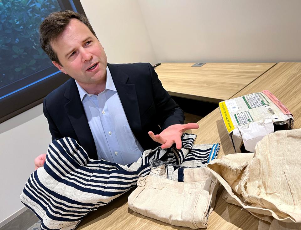 Bill Pulte opens a box on Dec. 13, 2021, he received from overseas. Pulte is known globally as a Twitter philanthropist. He has been a strong supporter of efforts to raise money for Oxford families.